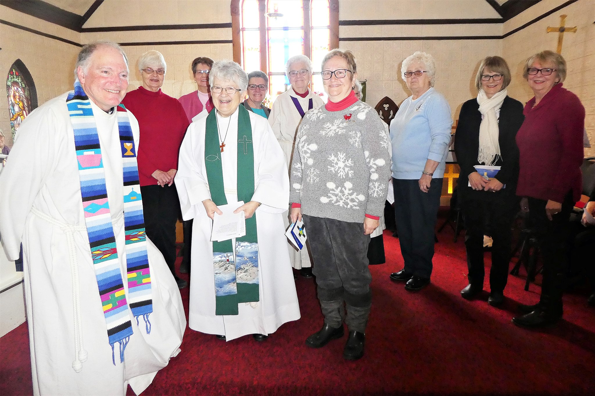 Clergy and parish members sharing fellowship inside the church